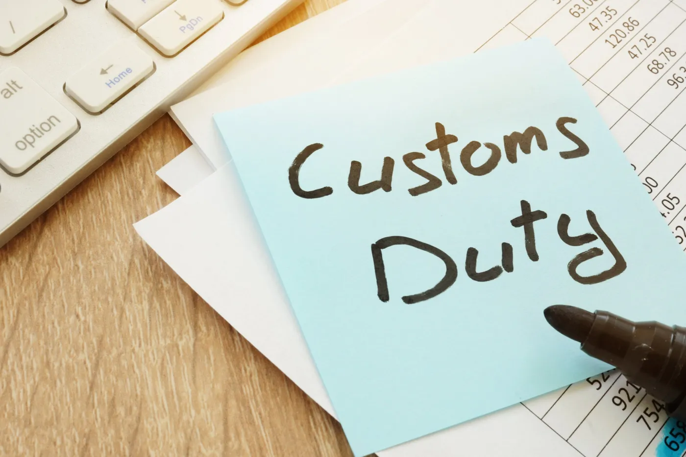 Customs duty note on a desk beside duty calculations